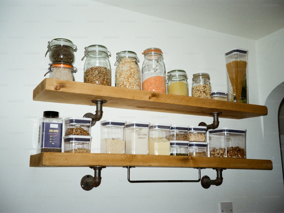 Wooden shelves filled with jars of dry goods
